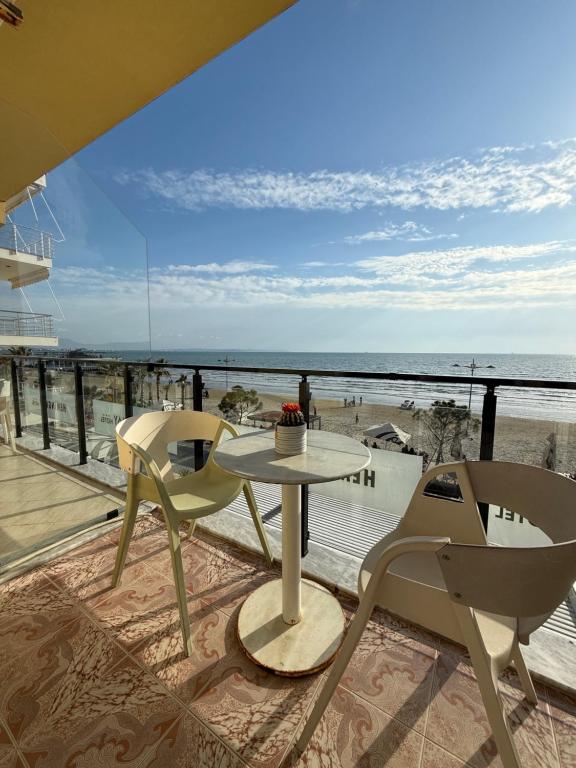 Private balcony with two chairs and a small table facing the Adriatic