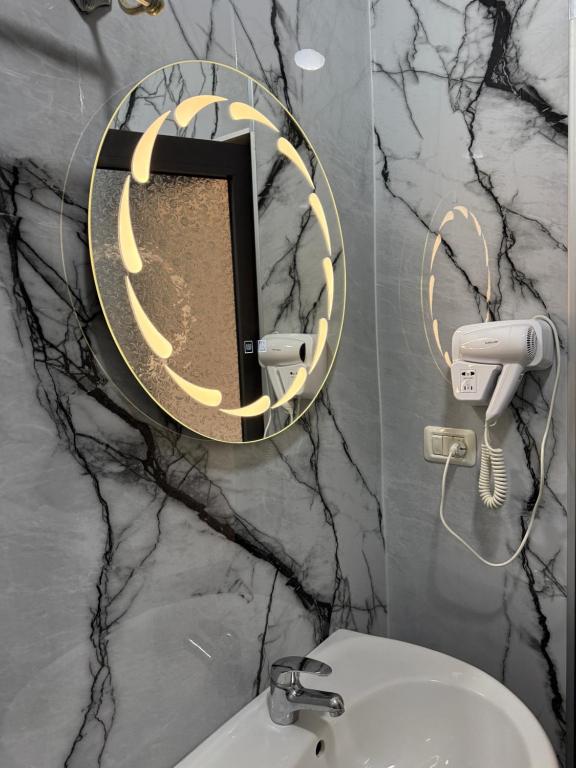 Bathroom detail with illuminated mirror and hairdryer