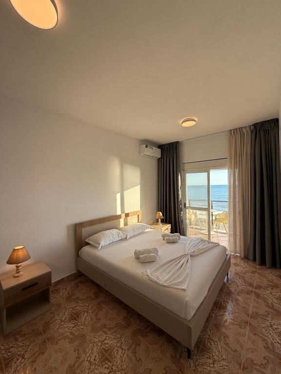 Bedroom with double bed and sea-view balcony doors