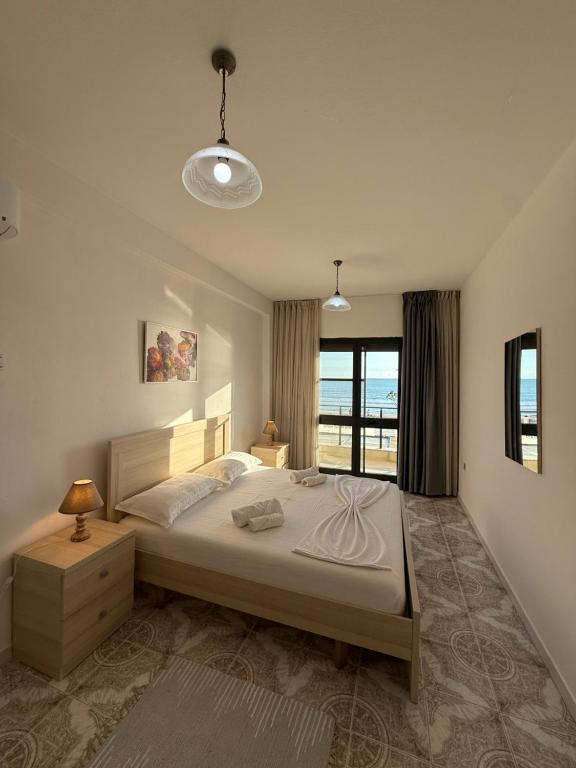 Bedroom with sea-view window and side tables