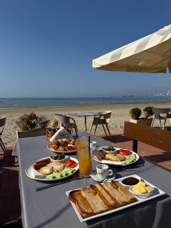 Breakfast served on a beachfront table with the Adriatic behind
