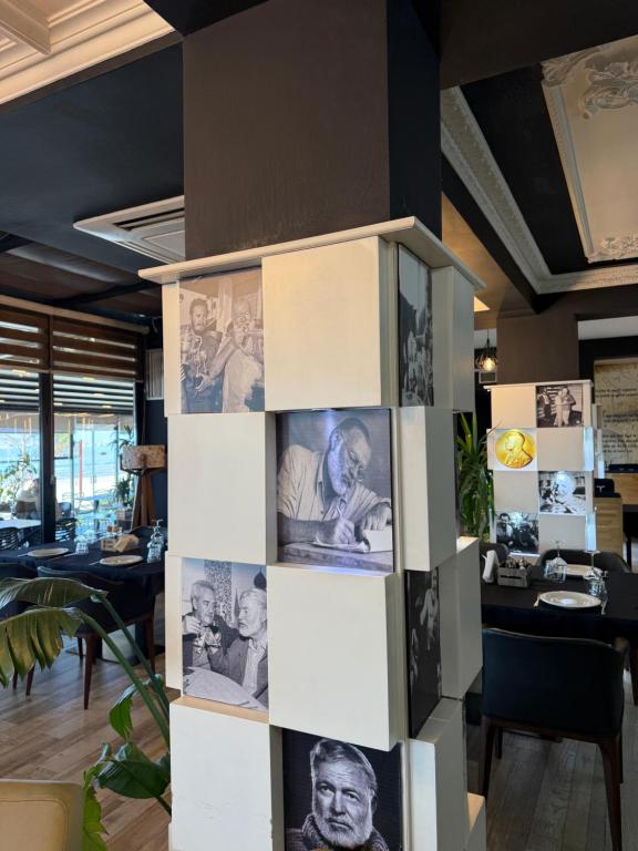 Column wrapped in black-and-white portraits of Ernest Hemingway