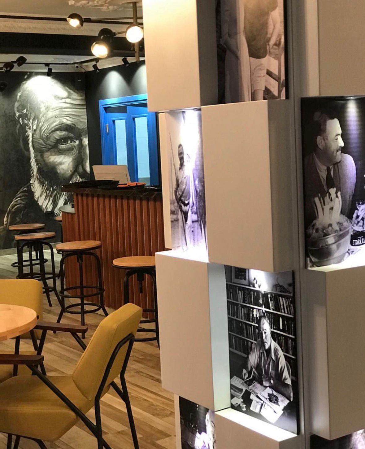 Interior with Hemingway portraits and dining tables