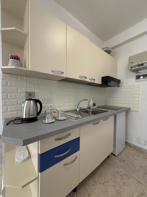 Kitchenette detail with kettle, glassware and blue accents