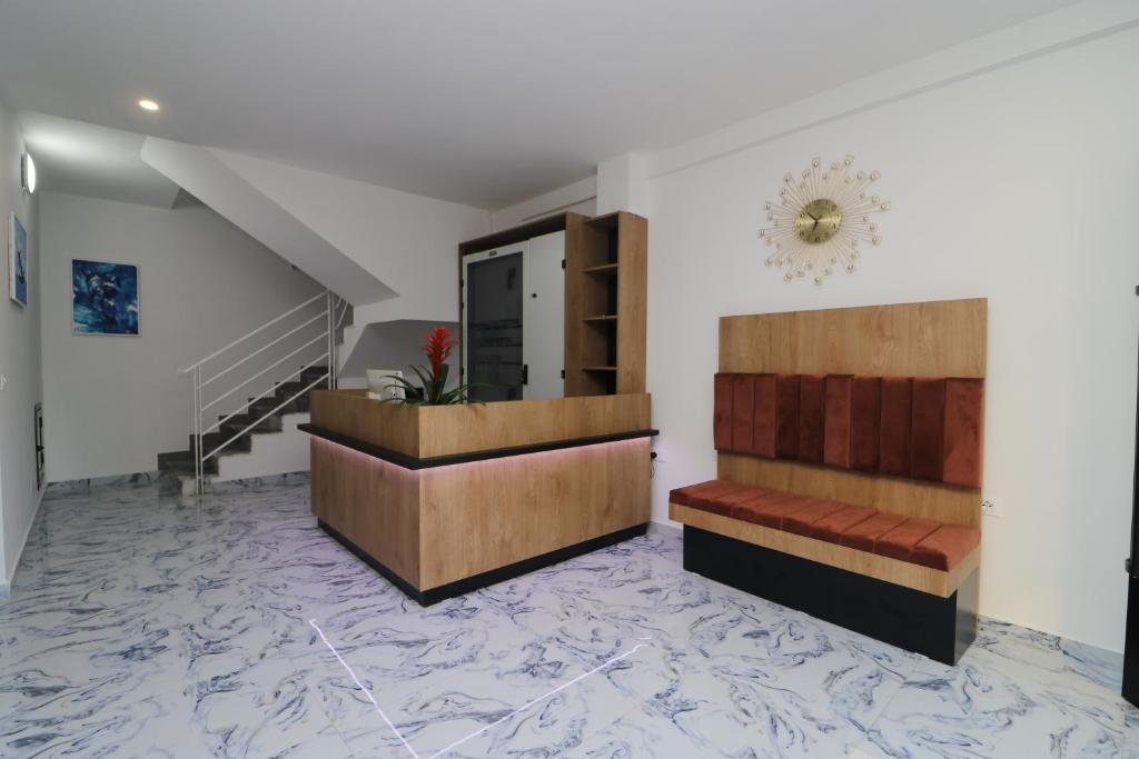 Wood-panelled reception desk with marble flooring