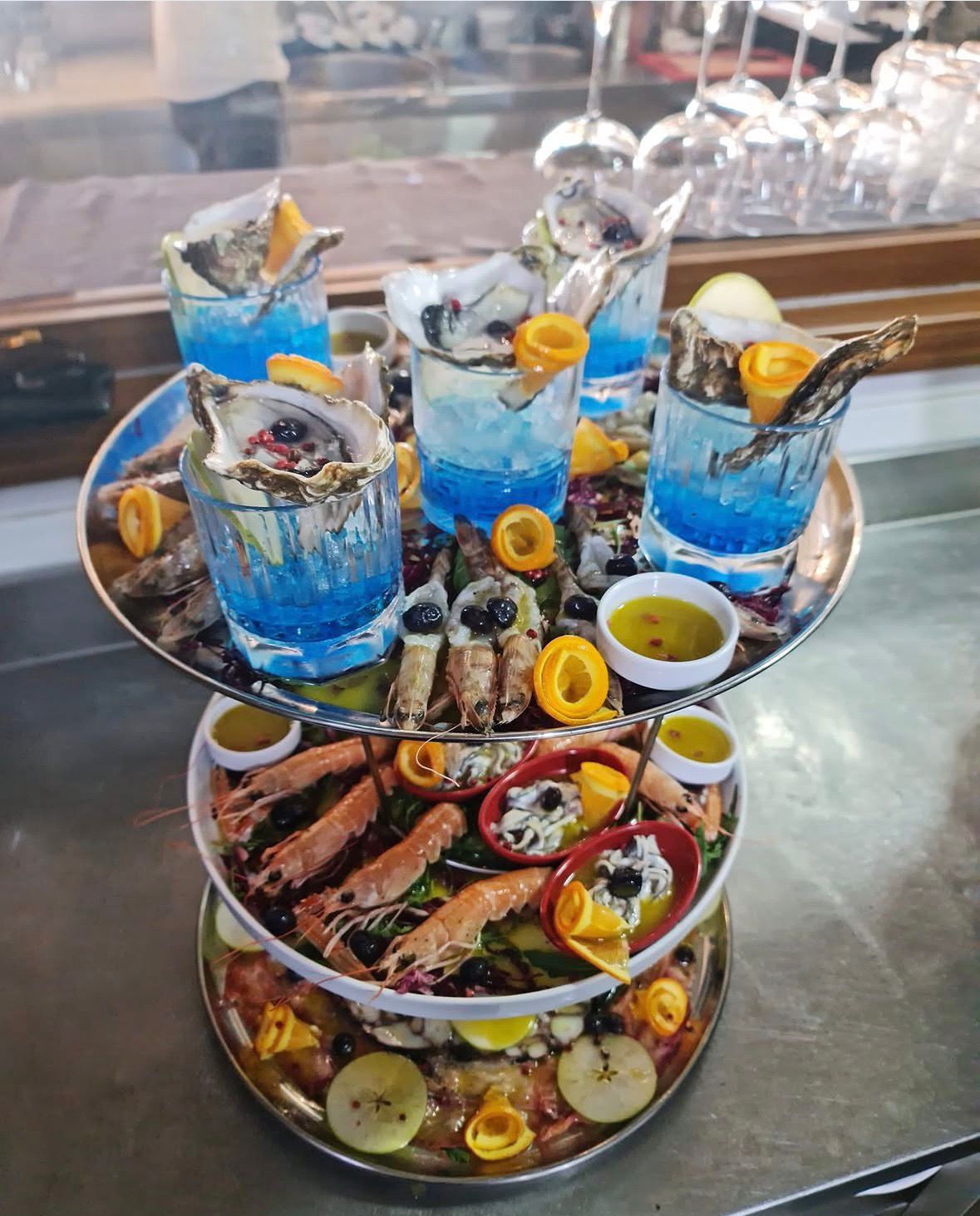 Tiered seafood tower with fresh oysters and langoustines