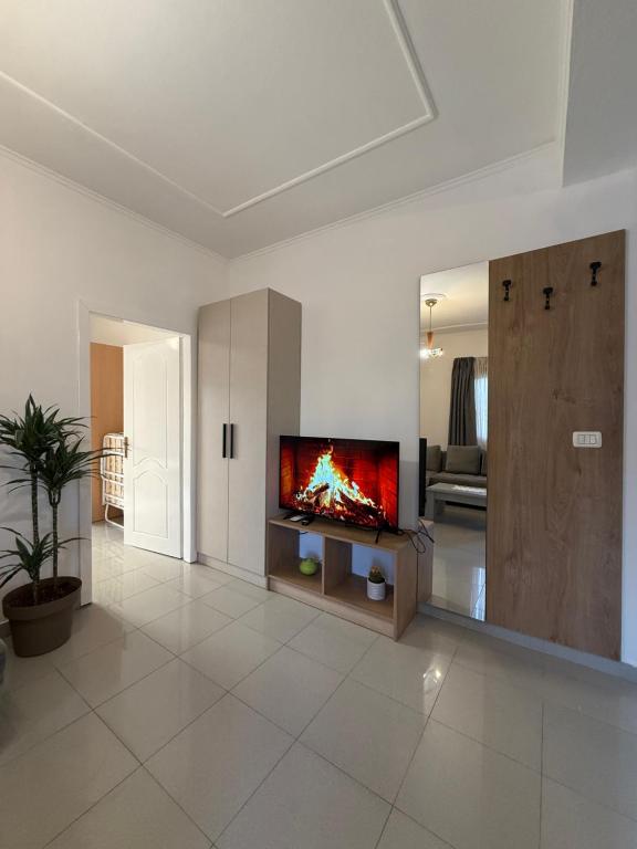 Suite with electric fireplace TV and warm wood detail