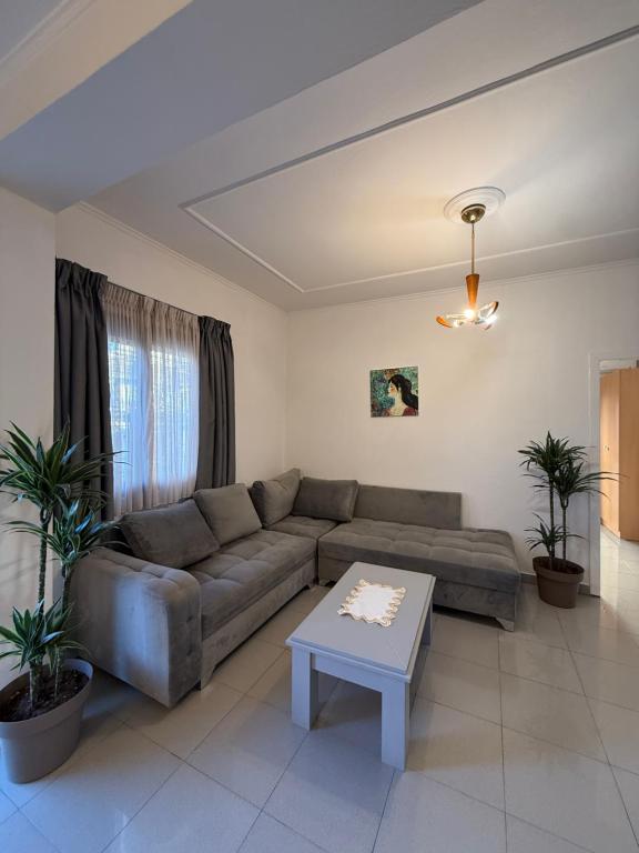 Suite with grey sectional sofa and tiled flooring