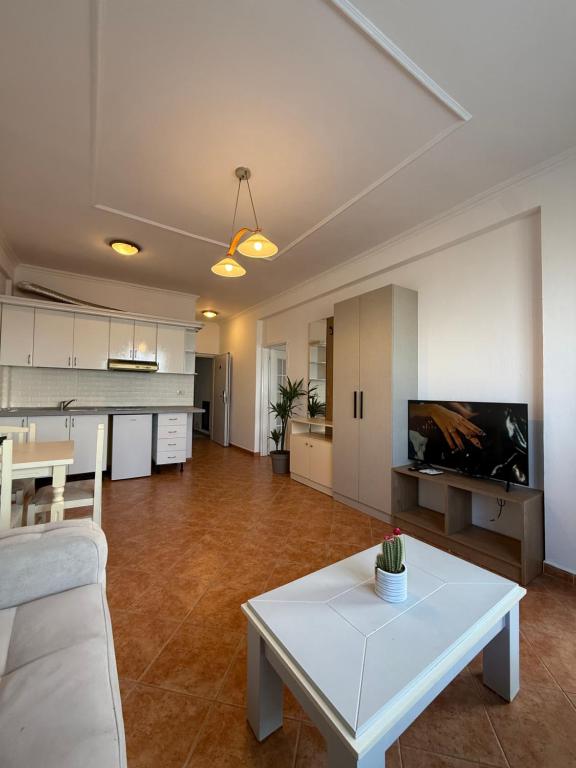 Suite living room with open kitchenette, sofa, and dining table