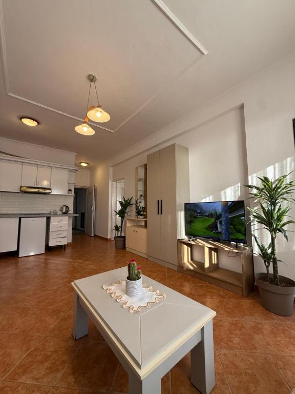 Wide view of suite living room with kitchen and dining