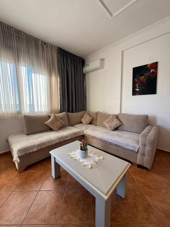 Suite with corner sectional sofa and curtained window